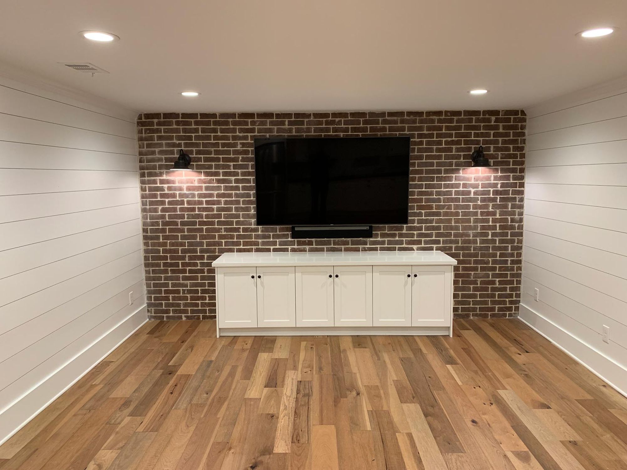 Brick accent wall with custom in-ceiling lighting