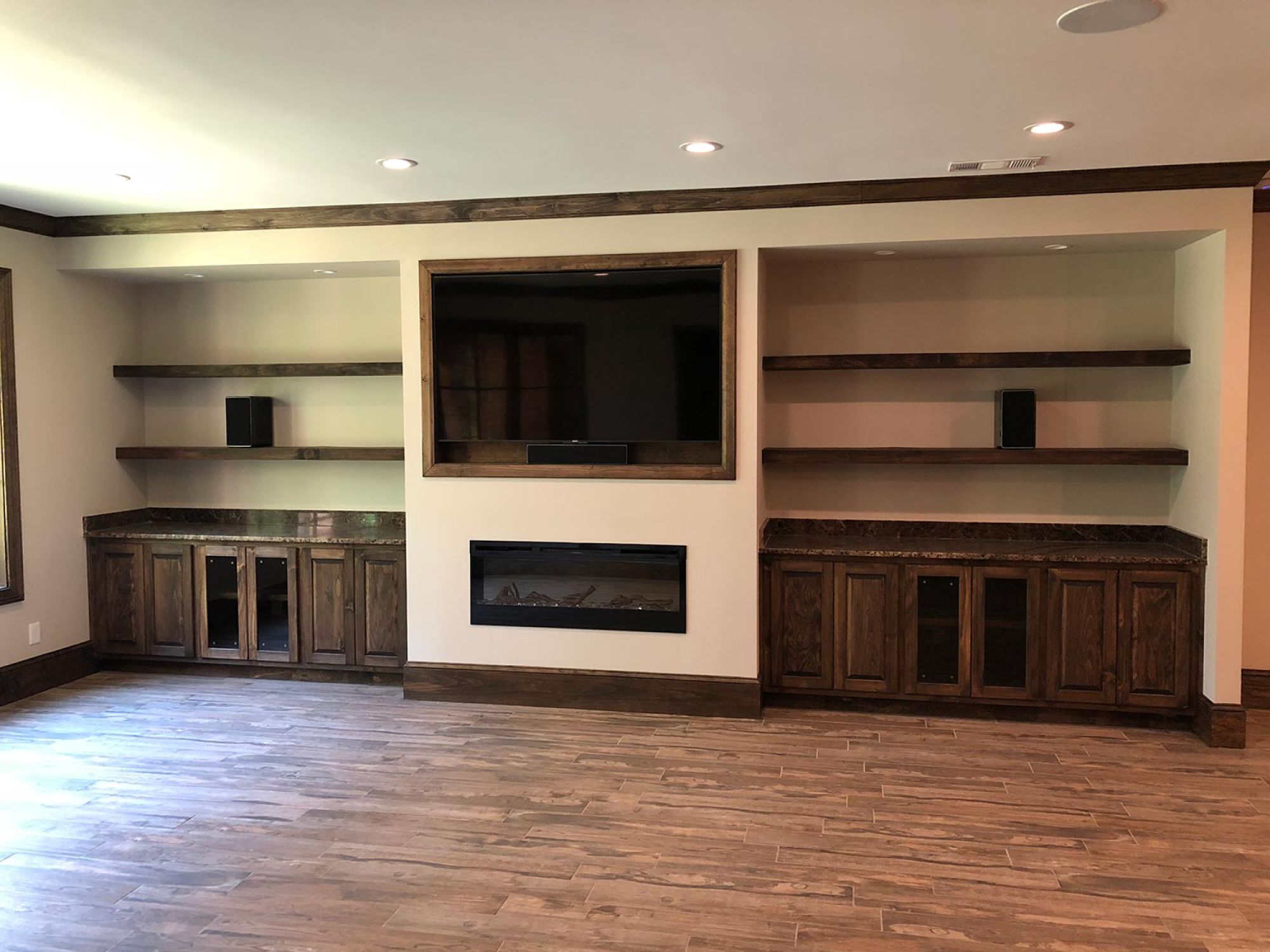 Custom furniture in accent wood wall with TV and fireplace